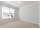 Bright, empty bedroom with neutral carpet and a large window, ready for personalization at 7525 Poplar Meadow Ln, Raleigh, NC 27616