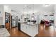 Modern, open-concept kitchen with stainless steel appliances, granite countertops, and a kitchen island at 7525 Poplar Meadow Ln, Raleigh, NC 27616