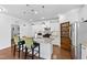 Well-lit kitchen featuring a large island, stainless appliances, custom cabinets, and hardwood floors at 7525 Poplar Meadow Ln, Raleigh, NC 27616