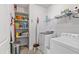 Functional laundry room featuring a washer, dryer, and ample shelving for storage at 7525 Poplar Meadow Ln, Raleigh, NC 27616