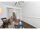 Inviting living room with hardwood floors and classic architectural details including wainscoting and ceiling fan at 7525 Poplar Meadow Ln, Raleigh, NC 27616