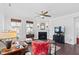 Comfortable living room with a fireplace, elegant decor, a ceiling fan and hardwood floors at 7525 Poplar Meadow Ln, Raleigh, NC 27616