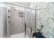 Modern shower with glass enclosure, tiled walls, and convenient built-in shelving at 7525 Poplar Meadow Ln, Raleigh, NC 27616