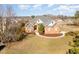 Aerial view of a traditional brick home with mature trees and a well-manicured lawn at 7800 Twin Pines Way, Fuquay Varina, NC 27526