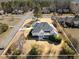 Scenic aerial shot of a house featuring a spacious backyard, mature trees, and a covered porch at 7800 Twin Pines Way, Fuquay Varina, NC 27526