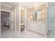 Bathroom with white cabinets, marble countertop, vanity area and marble tile flooring at 7800 Twin Pines Way, Fuquay Varina, NC 27526
