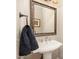 Powder room with pedestal sink and ornate framed mirror at 7800 Twin Pines Way, Fuquay Varina, NC 27526
