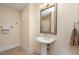 Bathroom featuring a pedestal sink, large mirror, and decorative shower curtain at 7800 Twin Pines Way, Fuquay Varina, NC 27526