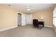 Bright bedroom with a ceiling fan, carpet, and a writing desk near a window at 7800 Twin Pines Way, Fuquay Varina, NC 27526