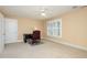 Bright bedroom with a ceiling fan, carpet, and a window with white shutters at 7800 Twin Pines Way, Fuquay Varina, NC 27526