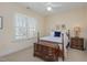 Cozy bedroom featuring a four-poster bed, ceiling fan, neutral color palette, and bright natural light at 7800 Twin Pines Way, Fuquay Varina, NC 27526