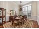 Formal dining room featuring elegant wood furniture, a large window, and striped wallpaper at 7800 Twin Pines Way, Fuquay Varina, NC 27526