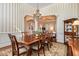 Elegant dining area showcasing a large table, ornate chairs, and views into the cozy living room at 7800 Twin Pines Way, Fuquay Varina, NC 27526