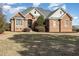 Charming brick home with manicured lawn and professional landscaping at 7800 Twin Pines Way, Fuquay Varina, NC 27526