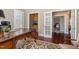 Private home office featuring a large desk, ample natural light, and access to other rooms at 7800 Twin Pines Way, Fuquay Varina, NC 27526