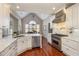 Well-equipped kitchen featuring stainless steel appliances and sleek white cabinetry at 7800 Twin Pines Way, Fuquay Varina, NC 27526