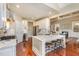 Bright kitchen with marble countertops, stainless appliances, breakfast bar, and open to the living area at 7800 Twin Pines Way, Fuquay Varina, NC 27526