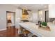 Gourmet kitchen with a marble island, stainless steel appliances, and adjacent breakfast bar at 7800 Twin Pines Way, Fuquay Varina, NC 27526
