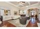 Spacious living room with coffered ceiling, hardwood floors, and views of the kitchen and dining area at 7800 Twin Pines Way, Fuquay Varina, NC 27526