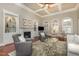Bright living room featuring a fireplace, built-in shelves, coffered ceiling, and comfortable seating at 7800 Twin Pines Way, Fuquay Varina, NC 27526