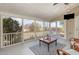 Screened porch with wood flooring, wicker seating, and views of the backyard at 7800 Twin Pines Way, Fuquay Varina, NC 27526