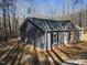 Newly constructed home featuring light blue siding and a grey roof in a wooded setting at 810 Jasmine Rd, Fuquay Varina, NC 27526