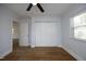 Bedroom featuring hardwood floors, a ceiling fan, a window and a large closet at 8125 Middleton Rd, Garner, NC 27529