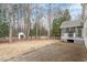 Spacious backyard featuring a screened porch, stone patio, and mature trees at 8513 Barrett Hall Ln, Wake Forest, NC 27587