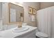 Stylish bathroom featuring a marble countertop sink, gold faucet, and framed mirror at 8513 Barrett Hall Ln, Wake Forest, NC 27587