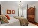 Bedroom with four-poster bed, framed prints, chandelier, and hardwood flooring with vintage wardrobe at 8513 Barrett Hall Ln, Wake Forest, NC 27587
