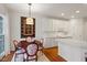 Charming dining area with hardwood floors, a window, and an elegant chandelier illuminating the space at 8513 Barrett Hall Ln, Wake Forest, NC 27587