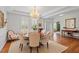 Elegant dining room with hardwood floors, chandelier and neutral décor is adjacent to the foyer at 8513 Barrett Hall Ln, Wake Forest, NC 27587