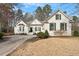 Beautiful brick home featuring manicured lawn, symmetrical windows, shutters and a covered entry way at 8513 Barrett Hall Ln, Wake Forest, NC 27587
