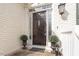 Charming entryway features a dark wooden door, sidelights, planters, and a decorative knocker at 8513 Barrett Hall Ln, Wake Forest, NC 27587