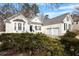 Charming home with white brick, green shutters, and a well-manicured front yard at 8513 Barrett Hall Ln, Wake Forest, NC 27587