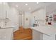 Bright kitchen with white cabinets, stainless steel appliances, a spacious island and hardwood floors at 8513 Barrett Hall Ln, Wake Forest, NC 27587