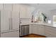 Updated kitchen with white cabinets, stainless steel appliances, ample counter space and hardwood floors at 8513 Barrett Hall Ln, Wake Forest, NC 27587