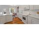 Updated kitchen with white cabinets, stainless steel appliances, breakfast nook and hardwood floors at 8513 Barrett Hall Ln, Wake Forest, NC 27587