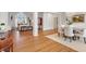 Spacious open-concept living and dining room with wood floors, white trim, and a decorative chandelier at 8513 Barrett Hall Ln, Wake Forest, NC 27587