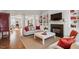 Cozy living room featuring a fireplace, built-in shelving, and neutral-toned furniture with red accents at 8513 Barrett Hall Ln, Wake Forest, NC 27587