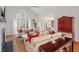 Light-filled living room with hardwood floors, vaulted ceilings, a fireplace, and large windows overlooking the yard at 8513 Barrett Hall Ln, Wake Forest, NC 27587