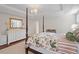 Spacious main bedroom featuring a four-poster bed, chandelier, and large dresser with gold-framed mirror at 8513 Barrett Hall Ln, Wake Forest, NC 27587