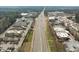 A commercial district featuring shopping centers and restaurants along a busy four-lane highway at 100 W Acres Cres, Cary, NC 27519