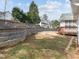 Large backyard features a tiered stone wall, a wooden deck, and plenty of space for outdoor activities at 100 W Acres Cres, Cary, NC 27519