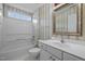 Well-maintained bathroom with bathtub and shower, vanity, and wallpaper at 100 W Acres Cres, Cary, NC 27519