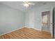 Bedroom with hardwood floors, a closet, a ceiling fan and a door leading to another room at 100 W Acres Cres, Cary, NC 27519