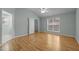 A bedroom with hardwood floors, a vaulted ceiling, and a large window with natural light at 100 W Acres Cres, Cary, NC 27519
