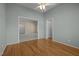 Bedroom with hardwood floors and door ways into other rooms at 100 W Acres Cres, Cary, NC 27519