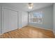 Bedroom with hardwood floors, natural light, closets, and a ceiling fan at 100 W Acres Cres, Cary, NC 27519