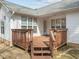 Cozy back deck perfect for relaxation and entertaining, featuring a wooden railing and stairs at 100 W Acres Cres, Cary, NC 27519